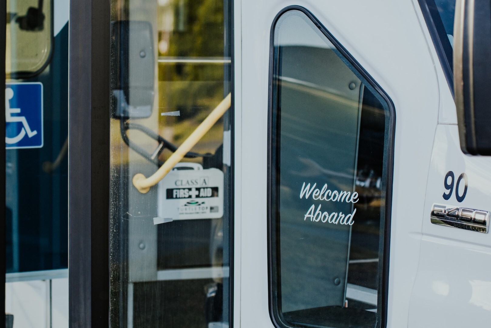 View of RCT shuttle bus door with decal that reads 'welcome aboard'