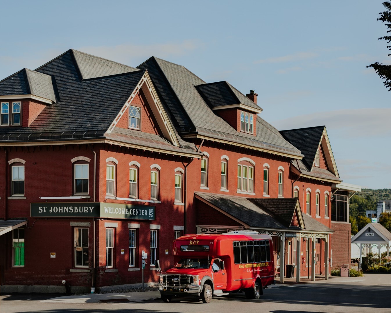 Photo of St. Johnsbury Welcome Center with RCT red shuttle bus stopped in front